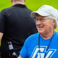 A guest holding a beer at the Jamie Hosford Football Center dedication.